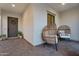 Inviting entryway with a stylish pod chair and front door, perfect for greeting guests at 19428 S 210Th Pl, Queen Creek, AZ 85142