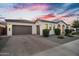 Attractive single-story home with brick driveway and dusk lighting at 19428 S 210Th Pl, Queen Creek, AZ 85142