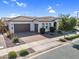 Beautiful single-story home with a two-car garage, tile roof, manicured landscaping, and neutral-toned exterior paint at 19428 S 210Th Pl, Queen Creek, AZ 85142