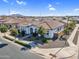 Aerial front exterior view of a single-story home with manicured landscaping, tile roof, and neutral-toned exterior paint at 19428 S 210Th Pl, Queen Creek, AZ 85142