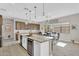 Open kitchen with a large island, granite countertops, and a built-in wine fridge at 19428 S 210Th Pl, Queen Creek, AZ 85142
