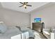 A main bedroom featuring a ceiling fan, a dresser with a TV, and a cozy chair at 19428 S 210Th Pl, Queen Creek, AZ 85142