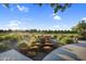 Whimsical playground featuring log steps and other structures in a lush, landscaped community at 19428 S 210Th Pl, Queen Creek, AZ 85142