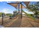 Shaded playground featuring slides and climbing area with wood chip ground covering and blue sky at 19428 S 210Th Pl, Queen Creek, AZ 85142