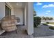 Covered porch with two pod chairs, perfect for relaxing and enjoying the outdoors at 19428 S 210Th Pl, Queen Creek, AZ 85142