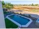 Aerial view of the backyard featuring pool, lounging area, and well-kept landscaping at 20139 N Bustos Way, Maricopa, AZ 85138