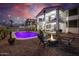 Inviting backyard features a sparkling pool, fire pit with chairs, and a charming two-story home with balconies at 20139 N Bustos Way, Maricopa, AZ 85138