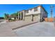 This home has an expansive driveway that leads to a three-car garage, providing ample parking at 20139 N Bustos Way, Maricopa, AZ 85138