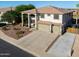 A two-story home with a three-car garage and a well-maintained desert-style front yard at 20139 N Bustos Way, Maricopa, AZ 85138