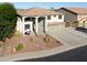 A two-story home with a three-car garage and desert landscaping at 20139 N Bustos Way, Maricopa, AZ 85138