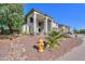 This two-story home boasts a stucco exterior, a tile roof, and a low-maintenance desert landscape at 20139 N Bustos Way, Maricopa, AZ 85138