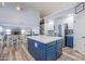 Kitchen island with quartz countertop, blue cabinetry, and stainless steel appliances in an open layout home at 20139 N Bustos Way, Maricopa, AZ 85138
