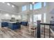 Well-lit kitchen with blue cabinets, a central island, and a breakfast nook at 20139 N Bustos Way, Maricopa, AZ 85138