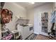 Laundry room with white washer and dryer, overhead storage, and shoe rack at 20139 N Bustos Way, Maricopa, AZ 85138