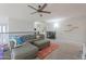 Comfortable living area showcasing a large sectional sofa, ceiling fan, and soft carpeting at 20139 N Bustos Way, Maricopa, AZ 85138
