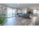 Open-concept living room with wood-look floors, sliding glass doors, and a view of the backyard pool at 20139 N Bustos Way, Maricopa, AZ 85138