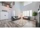 Open-concept living room with high ceilings, cozy seating, and stylish decor at 20139 N Bustos Way, Maricopa, AZ 85138