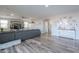 Bright living room with stylish decor, wood-look floors, and a comfortable gray sectional sofa at 20139 N Bustos Way, Maricopa, AZ 85138