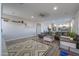 Open-concept living room with wood floors, ample seating, and designer decor at 20139 N Bustos Way, Maricopa, AZ 85138