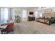 This spacious main bedroom features plush carpet, a cozy sitting area and a luxurious bed frame at 20139 N Bustos Way, Maricopa, AZ 85138
