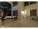 Inviting outdoor patio with comfortable seating and a charming front door at 20139 N Bustos Way, Maricopa, AZ 85138
