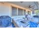 Spacious covered patio with outdoor seating, ceiling fans, and grill for relaxing at 20139 N Bustos Way, Maricopa, AZ 85138
