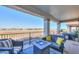 Covered patio features stylish outdoor furniture and a scenic view of the community at 20139 N Bustos Way, Maricopa, AZ 85138