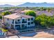 A multi-story home featuring a pool, backyard seating, and a small balcony on the second level at 20139 N Bustos Way, Maricopa, AZ 85138