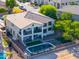 A multi-story home with a pool, backyard seating, and a small balcony on the second level at 20139 N Bustos Way, Maricopa, AZ 85138