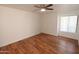 An empty bedroom shows wood floor and window with blinds at 2025 E Campbell Ave # 120, Phoenix, AZ 85016
