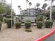 A landscaped entrance sign for Dakota at Scottsdale, a premium home community, with palm trees and inviting architecture at 2025 E Campbell Ave # 120, Phoenix, AZ 85016
