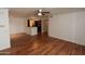 Spacious living room features hardwood floors, a ceiling fan, and open concept kitchen at 2025 E Campbell Ave # 120, Phoenix, AZ 85016