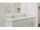This bathroom has a double vanity with white countertops and modern fixtures at 20795 N Roadrunner Ln, Maricopa, AZ 85138