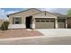 Charming single-story home with a two-car garage and desert landscaping at 20795 N Roadrunner Ln, Maricopa, AZ 85138