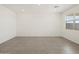 Living room with tile flooring, recessed lighting, and a bright window at 20795 N Roadrunner Ln, Maricopa, AZ 85138