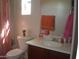 Bathroom with a toilet, dark wood vanity, sink, mirror, and a shower with a striped curtain at 21050 E Munoz St, Queen Creek, AZ 85142
