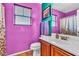 A colorful bathroom features a single sink vanity and a toilet at 21050 E Munoz St, Queen Creek, AZ 85142