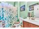 A full bathroom features a tiled shower and a vanity sink at 21050 E Munoz St, Queen Creek, AZ 85142