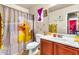 Bathroom with a charming yellow rubber ducky shower curtain and matching decor at 21050 E Munoz St, Queen Creek, AZ 85142