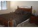 Bedroom with a queen-sized bed, dark wooden frame, and matching nightstands, creating a cozy atmosphere at 21050 E Munoz St, Queen Creek, AZ 85142