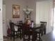 Dining room with a dark wood table, six chairs, a chandelier, and lots of sunlight at 21050 E Munoz St, Queen Creek, AZ 85142