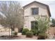 Charming two-story home with manicured landscaping and neutral-colored exterior at 21050 E Munoz St, Queen Creek, AZ 85142