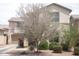 Lovely home featuring a two-car garage, lush landscaping, and a well-maintained lawn at 21050 E Munoz St, Queen Creek, AZ 85142