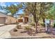 Charming home with a well-maintained front yard, desert landscaping, and covered entryway at 21050 E Munoz St, Queen Creek, AZ 85142