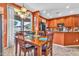 A dining area adjacent to a kitchen features a wooden table and natural light at 21050 E Munoz St, Queen Creek, AZ 85142