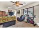 Comfortable living room with carpet, natural light, and an exercise bike by the window at 21050 E Munoz St, Queen Creek, AZ 85142