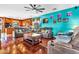 The living room features hardwood floors, a ceiling fan and two sofas at 21050 E Munoz St, Queen Creek, AZ 85142