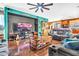 The living room features hardwood floors, a ceiling fan and a TV at 21050 E Munoz St, Queen Creek, AZ 85142