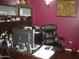 Home office with a large desk, comfortable leather chair, and a computer monitor, designed for productivity at 21050 E Munoz St, Queen Creek, AZ 85142