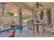 A relaxing outdoor patio with a ceiling fan, furniture set, and outdoor kitchen at 21050 E Munoz St, Queen Creek, AZ 85142